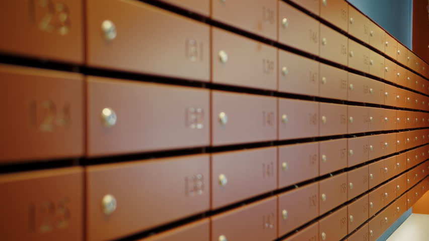 Long wall of numbered apartment mailboxes