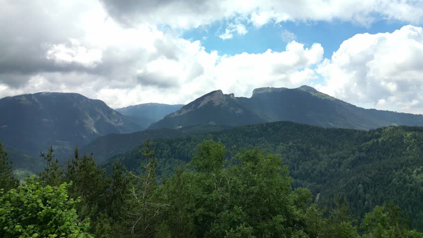 An aerial view of a high mountain over the trees.An aerial view of a high mountain over the trees.