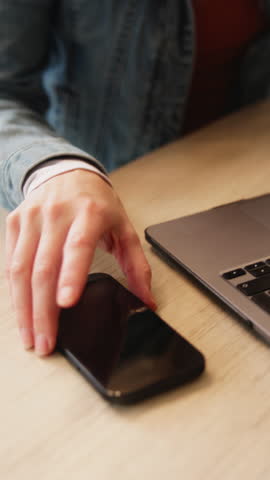 Texting, online and woman with phone in cafe, info and article research with laptop and remote work. Creative, writer and happy person with mobile, chat and reading message on social media in shop