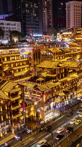 CHONGQING, CHINA - 28 MAY 2026: Timelapse of the amazing Chongqing cyberpunk city skyline and hongyadong cave from unique high vantage at night in vertical