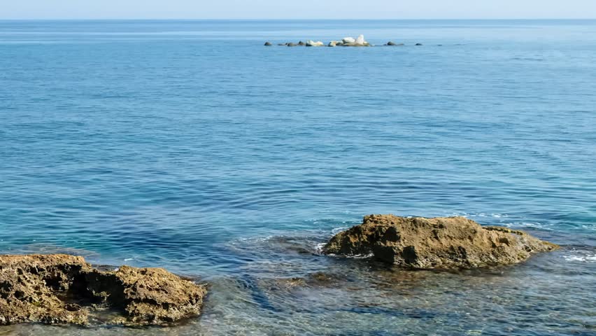 Video of the rocky shore of Crete Island with blue clear transparent Mediterranean sea water. Greece.