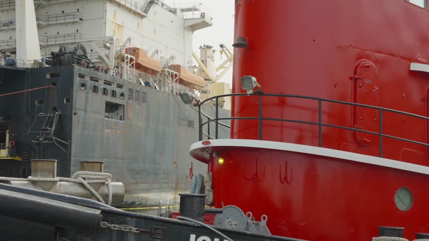 Cargo Ship and Red Tugboat at Industrial Port Pensacola Florida