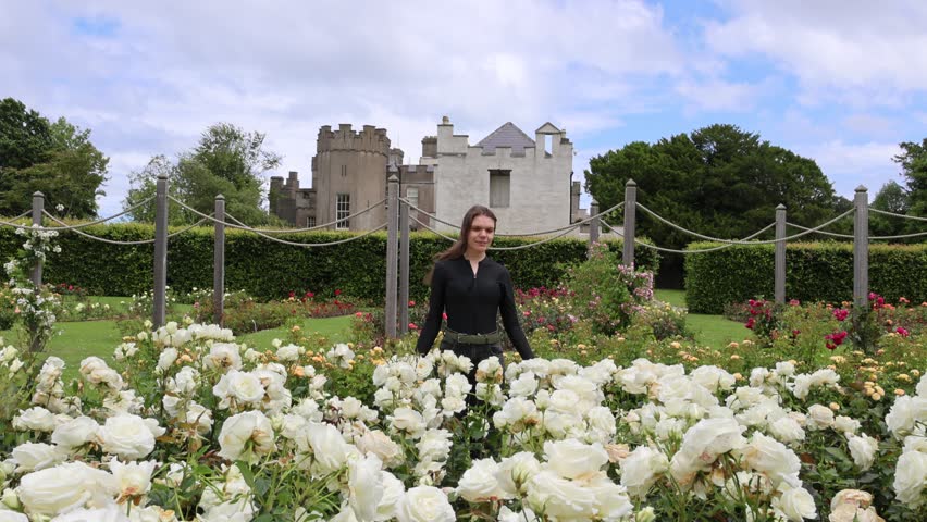 Woman in Beautiful Rose Garden at Ardgillan Castle and Demesne, Ireland with Lily Pond and Fountain