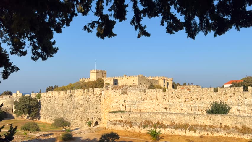 View of the Saint Nicholas Fort through the trees in Rhodes city, Greece
