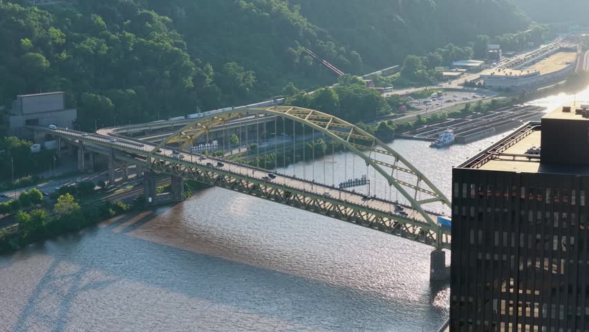 Cars driving over a bridge along the Monongahela River in Pittsburgh Pennsylvania USA