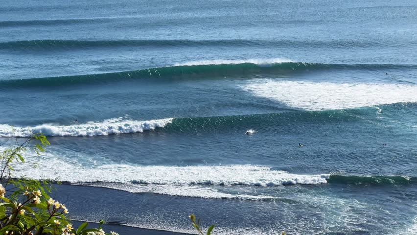Surfers riding waves in the open ocean