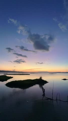 Timelapse of Serene Sunset Over Calm Water