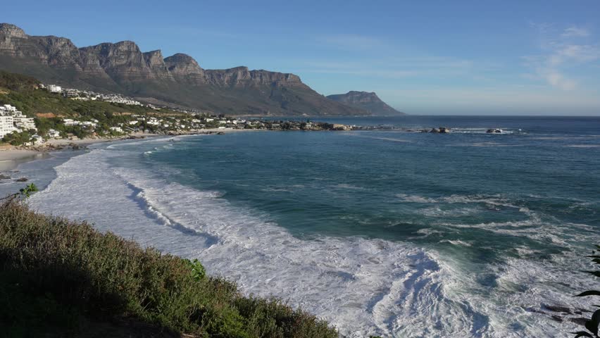 4K 30fps footage overlooking the iconic Clifton Beach coastline in Cape Town, South Africa, showcasing pristine white sand, turquoise Atlantic Ocean water and the spectacular Atlantic Seaboard scenery.
