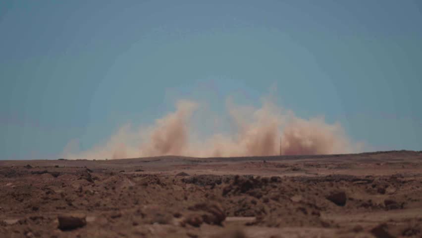Wide shot of dust smoke in desert background, Chile