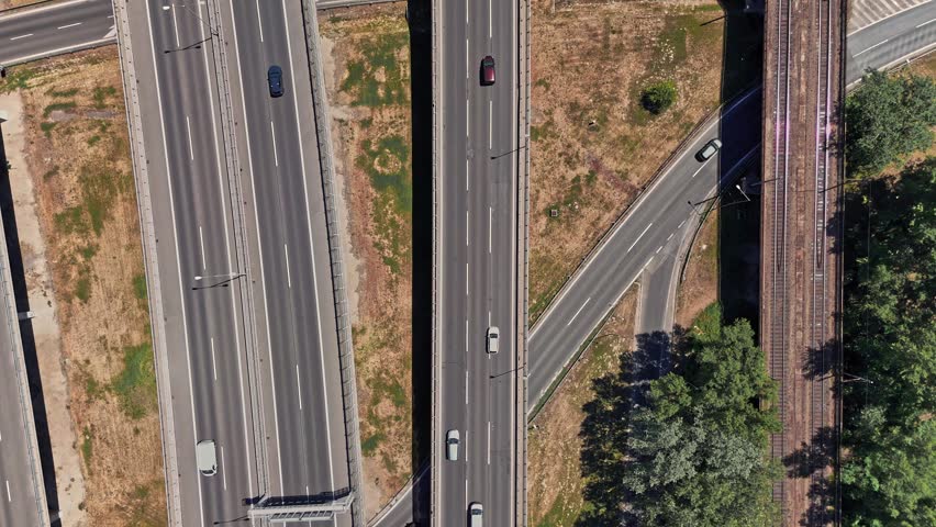 Cars drive on various roads in Bratislava, Slovakia under clear skies. The scene shows the city