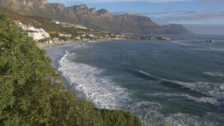 4K 30fps footage overlooking the iconic Clifton Beach coastline in Cape Town, South Africa, showcasing pristine white sand, turquoise Atlantic Ocean water and the spectacular Atlantic Seaboard scenery.