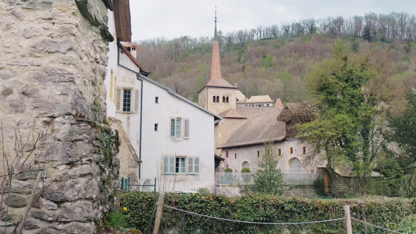 Romainmotier Priory and buildings of the village, former Cluniac priory, during the day in canton of Vaud, Switzerland