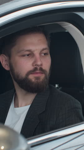 Vertical Video Sales manager handing over the keys to man that sitting in the car.