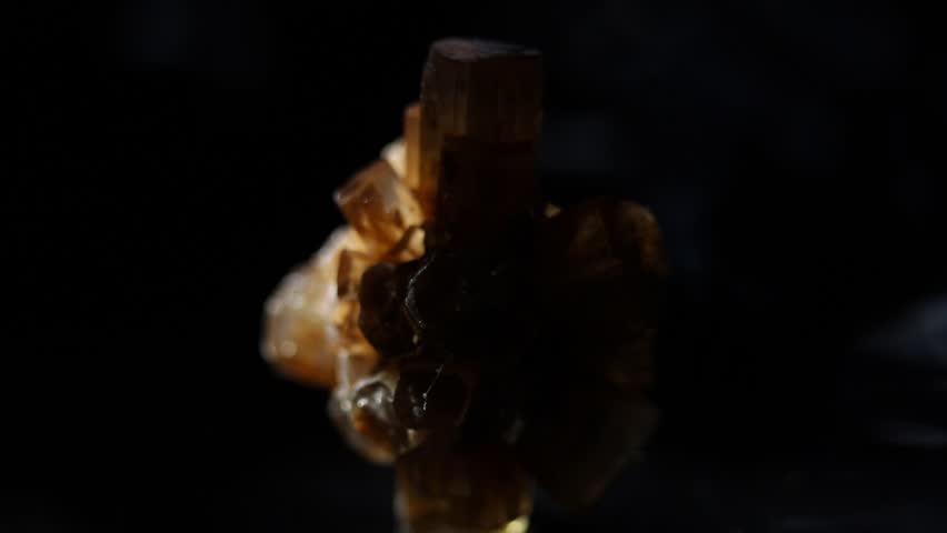 Aragonite mineral close up on black background. Dramatic light, reflections. Slow zoom. Macro video of hedgehog or sputnik cluster