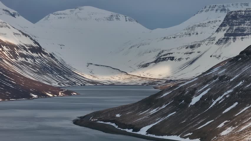 Snowy Landscape Of The Sugandafjordur Fjord Located In The Westfjords Region Of Iceland. - aerial lateral shot