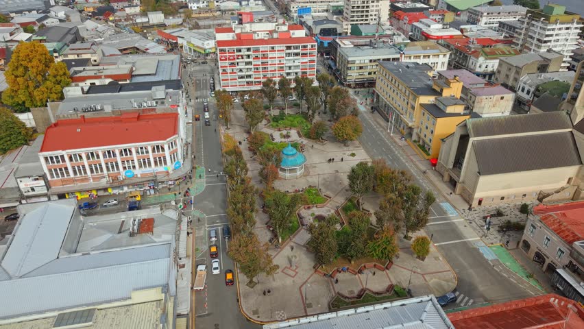 Panoramic aerial view of Square of the Republic in downtown Valdivia, Chile, on a sunny morning, with people walking and a mix of architectural styles