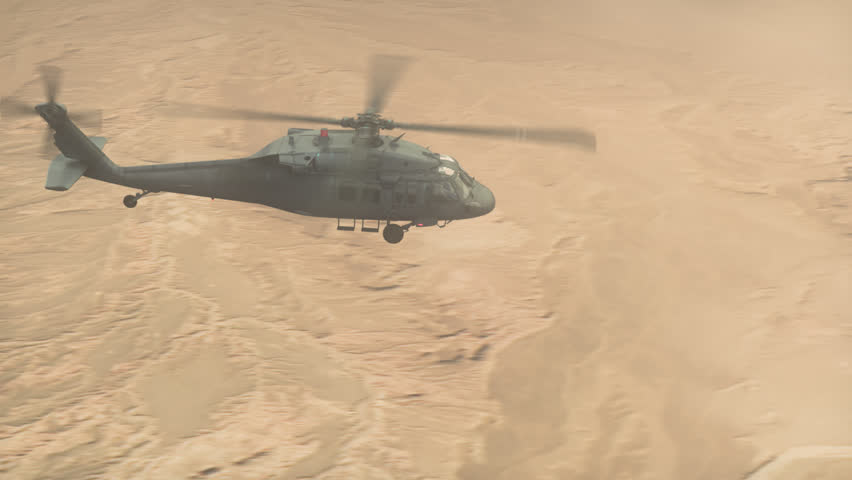 A utility helicopter flies over the desert in strong winds. Production Quality Footage in 4k resolution, ProRes 4444 codec, 25 FPS.