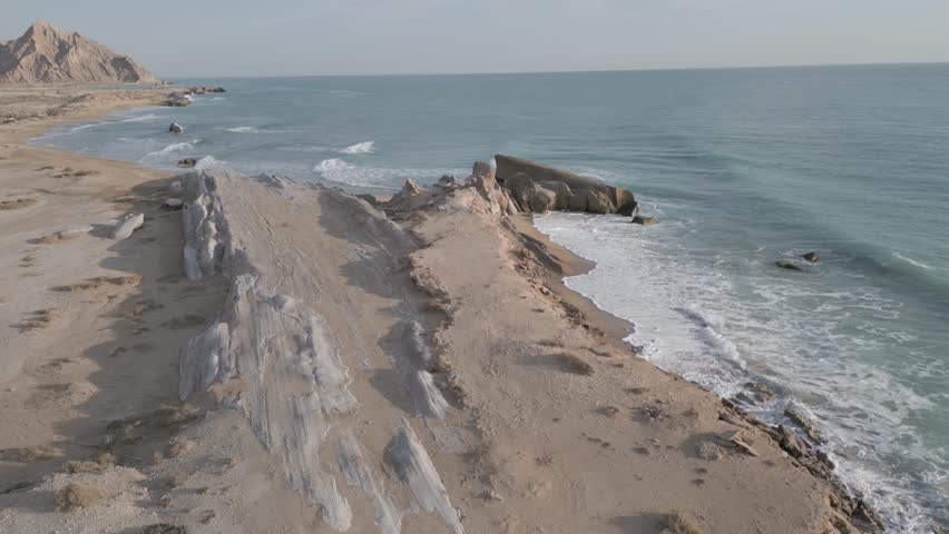 Martian landscape scenic land on Earth beside ocean mountain cliff of rock wind erosion in beach maritime coastal hills of Qeshm Qatar Oman Iran and natural landform of Persian Gulf in Arabian culture