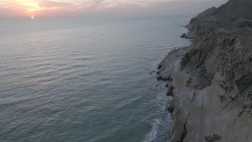 Coastal headland in Iran UAE strait of hormuz coast geology of canyon desert erosion sandstone cliff seascape sunrise tourism nature rocky shoreline waves panorama travel scenic rugged gulf landscape