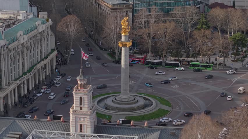 Drone shot capturing the golden St George statue at Freedom Square in Tbilisi, highlighting the landmark at the heart of the city.