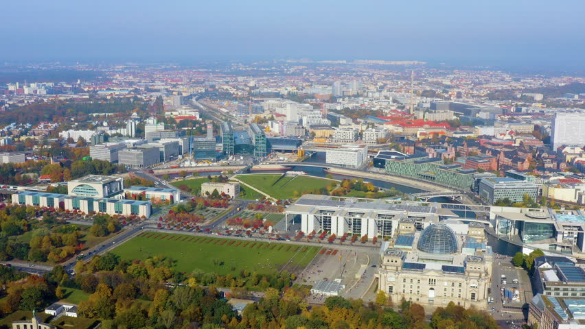 Aerial drone view of the Berlin government district with the Reichstag, Bundeskanzleramt, Hauptbahnhof, and the Spree River bend in Berlin, Germany, autumn daytime.