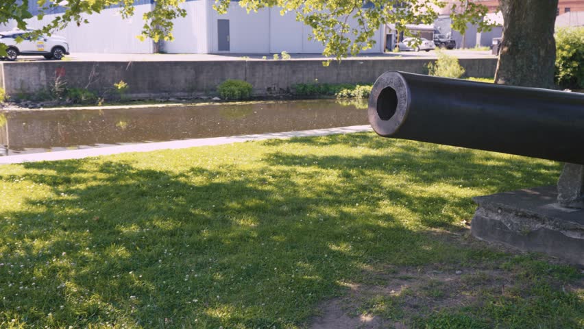 Wide shot of a Civil War cannon landmark in a park