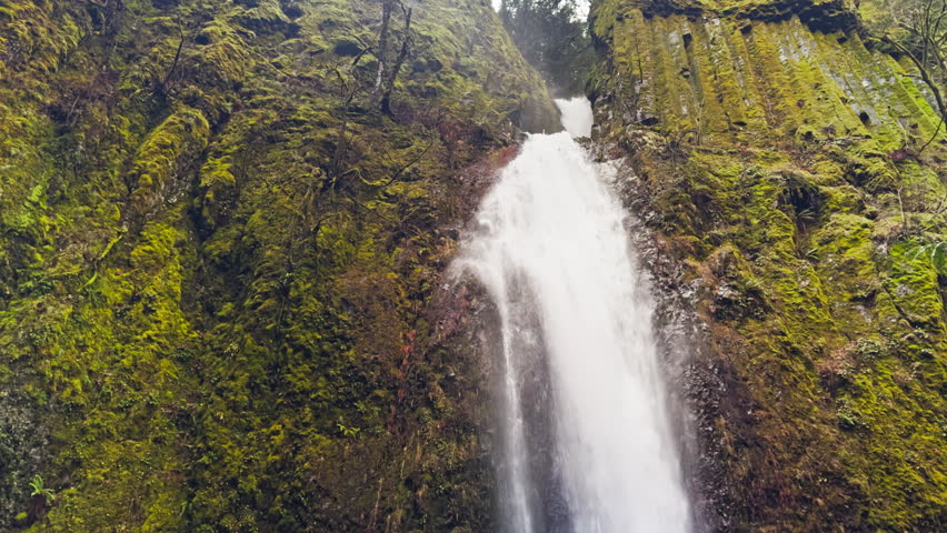 Close details of waterfall plunging into pool with descending water flow, tilt down tracking to base, Dry Creek Falls Oregon