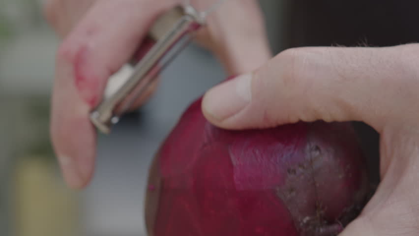 A man grating a beetroot