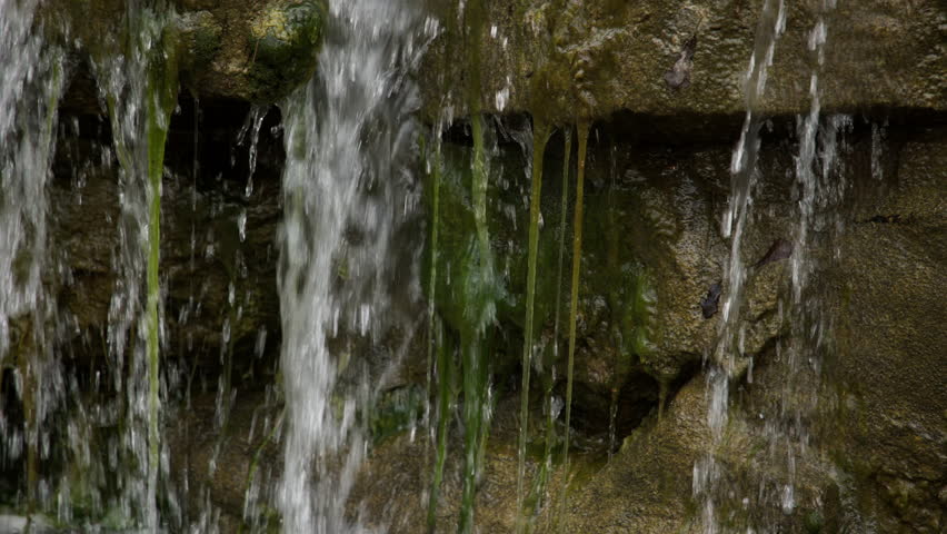 Small waterfalls over mossy rocks