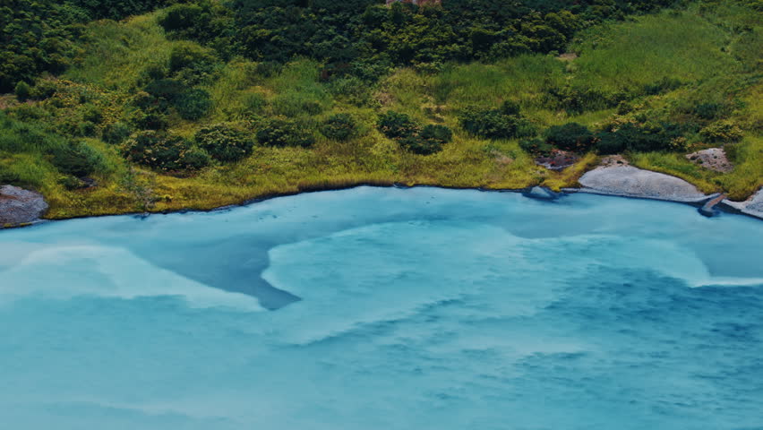 Lake with milky blue boiling water in the active volcanic area of volcano of Golovnin on Kunashir island in Russia