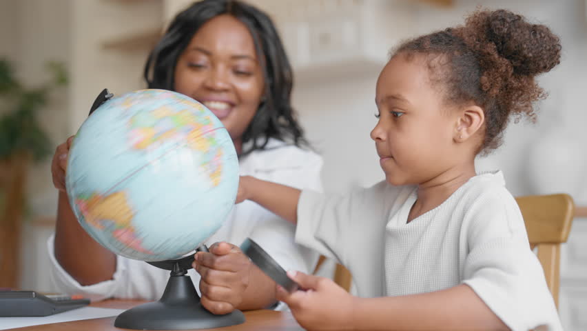 Enjoy childhood and motherhood, black girl spinning globe, happy family moments. Fun geography for little children in primary school, african american teacher and pupil, education for preschoolers