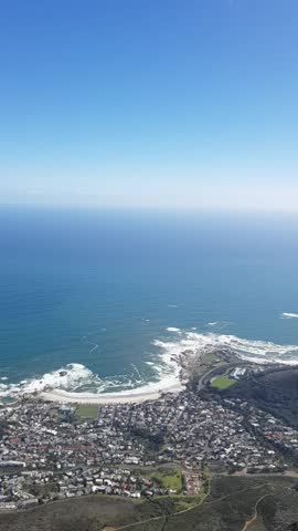 Standard panning shot of Cape Town cityscape, harbor, and the blue ocean bay captured from the top of Table Mountain, South Africa.