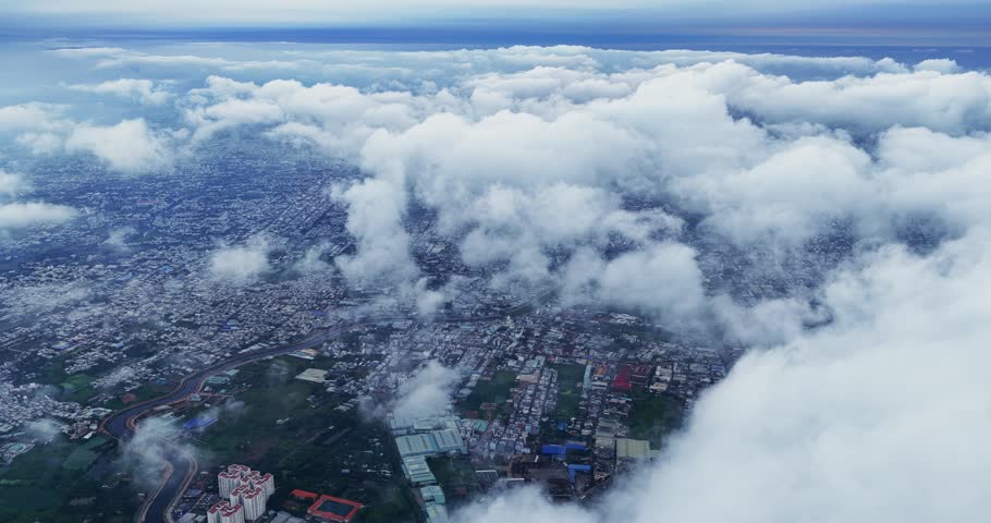 Aerial view of Saigon cityscape at morning with misty sky in Southern Vietnam. Urban development texture, transport infrastructure and green parks