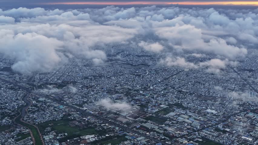 Hyperlapse of Saigon cityscape at morning with misty sky in Southern Vietnam. Urban development texture, transport infrastructure and green parks