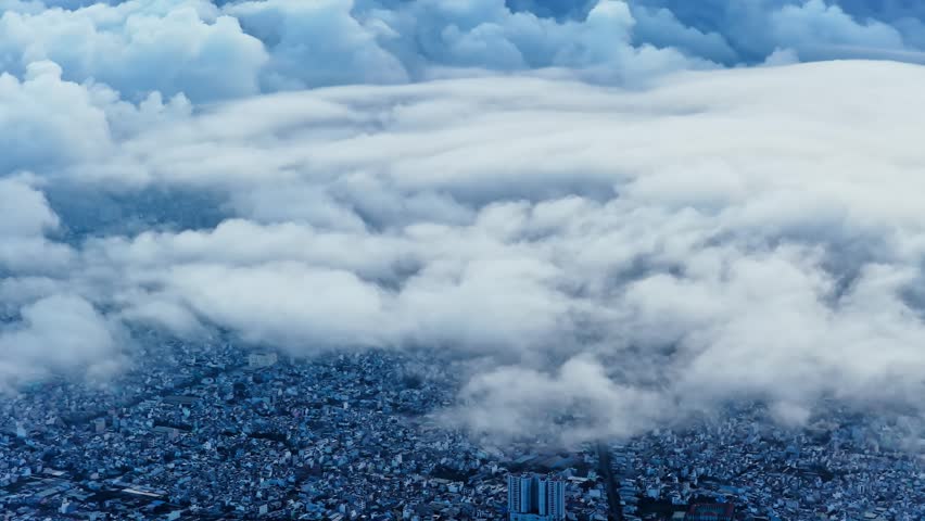 Aerial view of Saigon cityscape at morning with misty sky in Southern Vietnam. Urban development texture, transport infrastructure and green parks