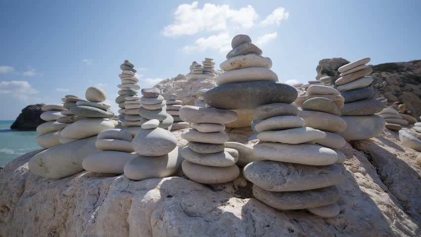 Close up of carefully balanced stones forming cairns on the beach near Aphrodite