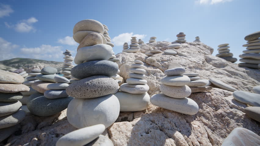Close up of carefully balanced stones forming cairns on the beach near Aphrodite