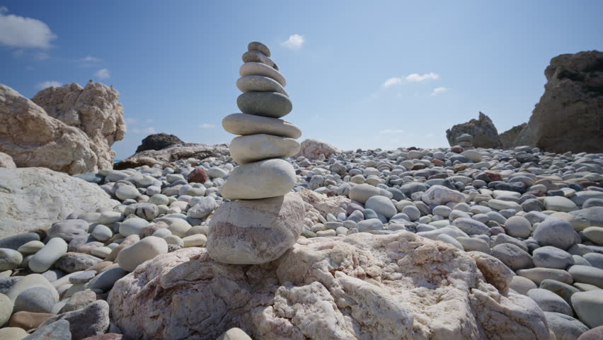 Close up of carefully balanced stones forming cairns on the beach near Aphrodite