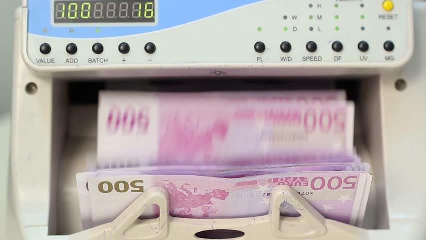 High Speed Digital Money Counter Processing Euro Banknotes Banking Technology. A frontal close-up shot of an electronic money counting machine processing 500 euro banknotes at high speed, clearly showing the digital LED display and control buttons. This conceptual stock video is ideal for projects exploring banking automation, financial technology, macroeconomics, cash flow analysis, corporate revenue auditing, and modern eurozone financial systems.