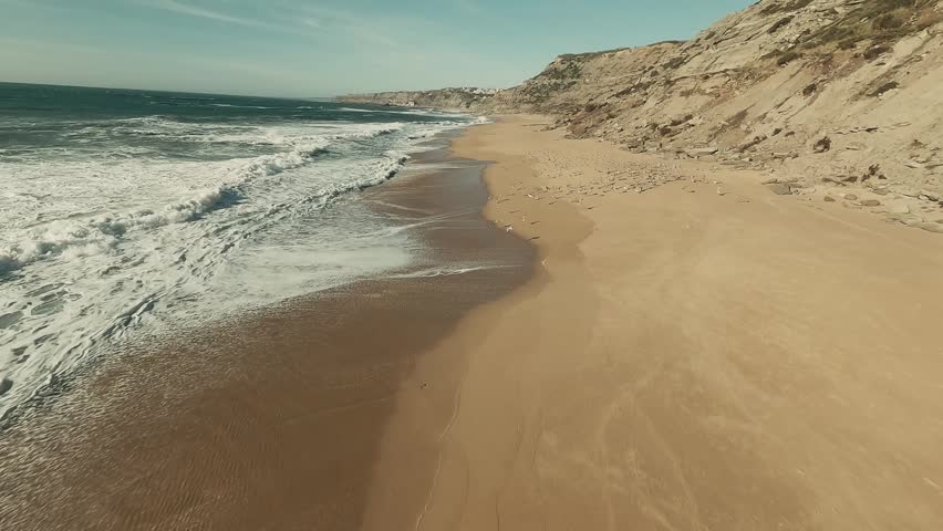Cinematic FPV drone footage of a huge flock of birds taking off from sandy beach
