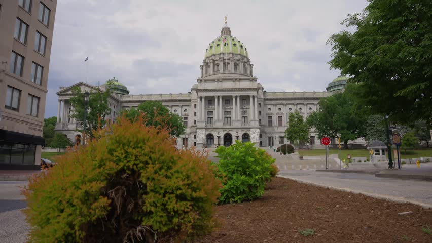 Dolly up shot revealing the Pennsylvania State Capitol in Harrisburg Pennsylvania highlighting historic government architecture civic design and a prominent state landmark.