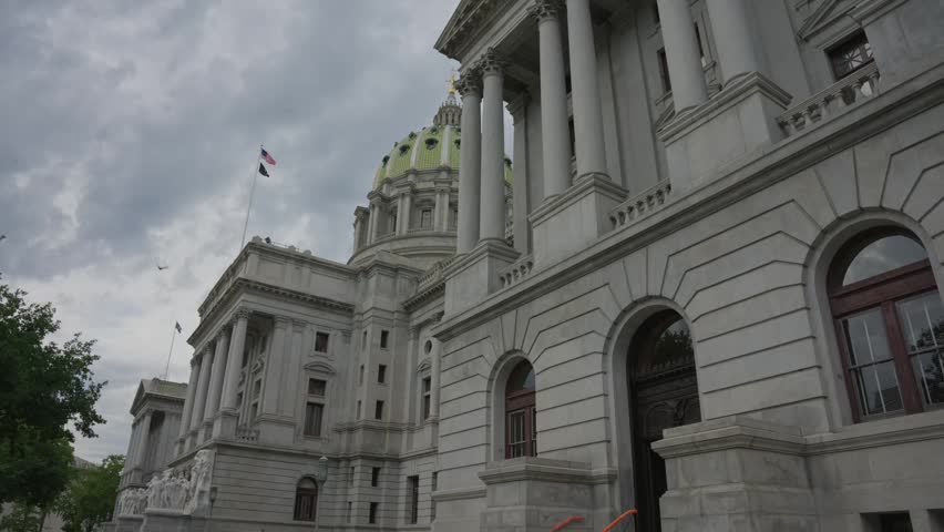 Slow dolly movement from right to left across the Pennsylvania State Capitol in Harrisburg Pennsylvania showcasing historic government architecture and civic landmark details.
