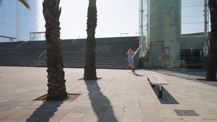 Young blonde woman roller skating in a sunny urban plaza