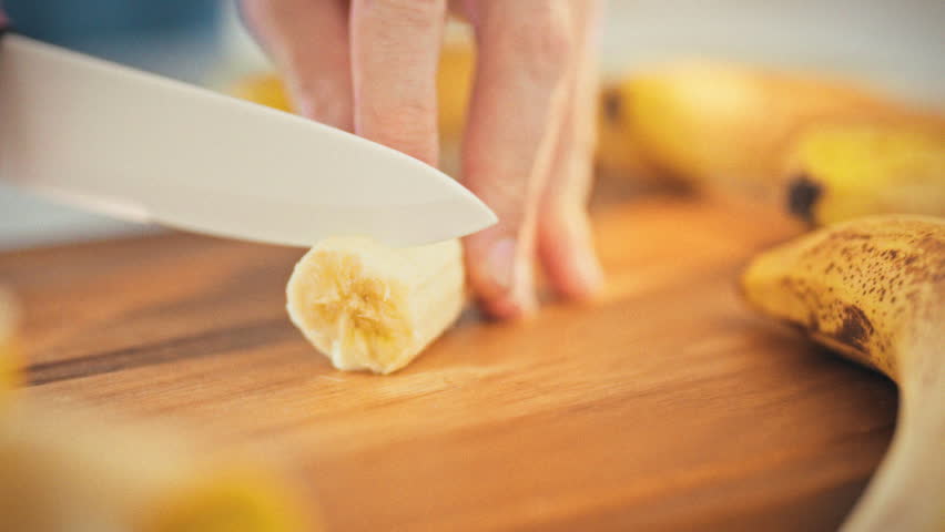In a warm home kitchen bathed in sunny light, a man