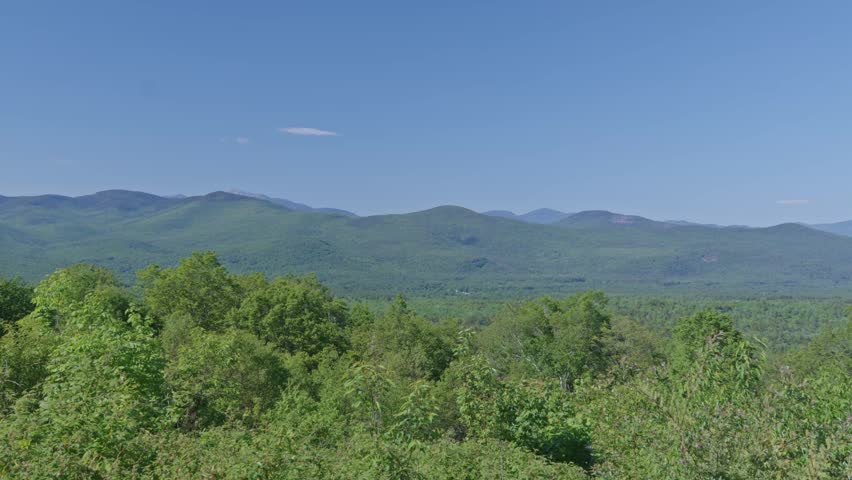 Panorama view of White Mountain National Forest environment and distant Mount Washington range from Bear Notch Rd, New Hampshire, US