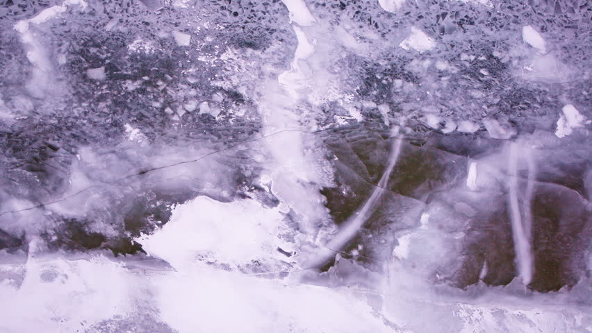 Overhead aerial view of winter ice scattered across the surface waters of the Great Lakes.