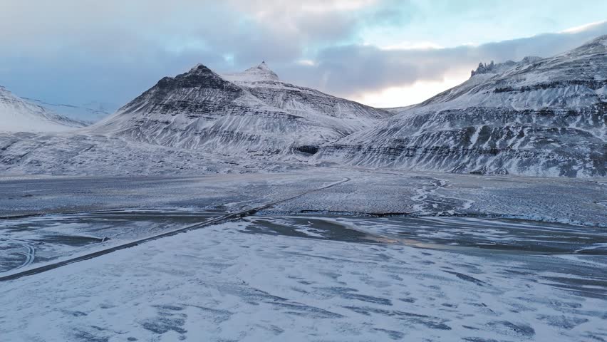 Aerial view of snowy mountains and frozen valley in Iceland