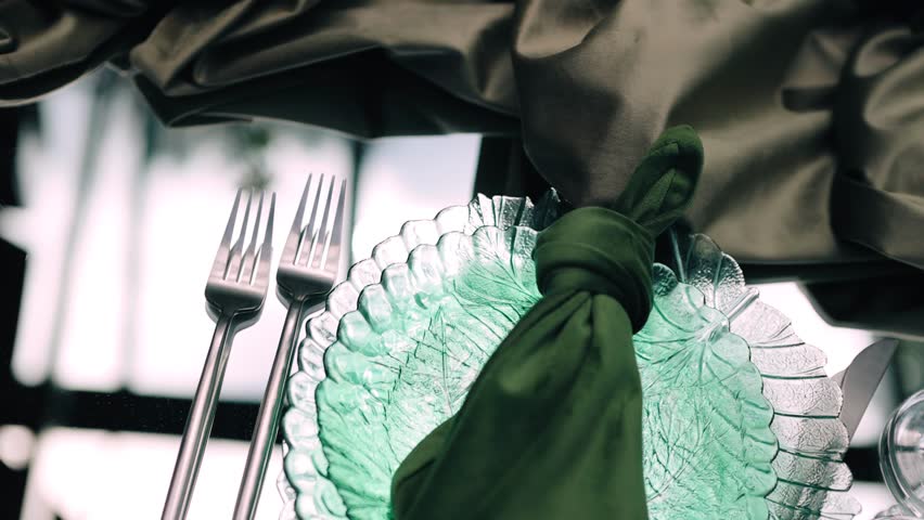 Two forks are lying next to a plate on the table. There will be an event soon