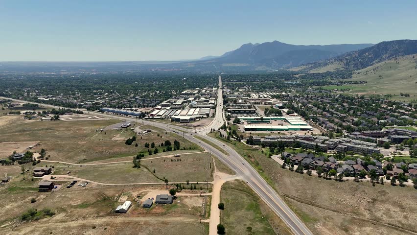 Aerial view of the suburban landscape, road network, and distant mountains near Boulder, Colorado, United States.