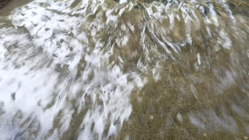 A stream of water flowing from the rocks—a truly beautiful sight